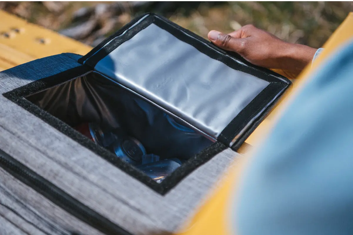 An overhead shot of the Herschel Pop Quiz Cooler 30 Pack Insulated with it's top-access pocket open showing the insulated inside.