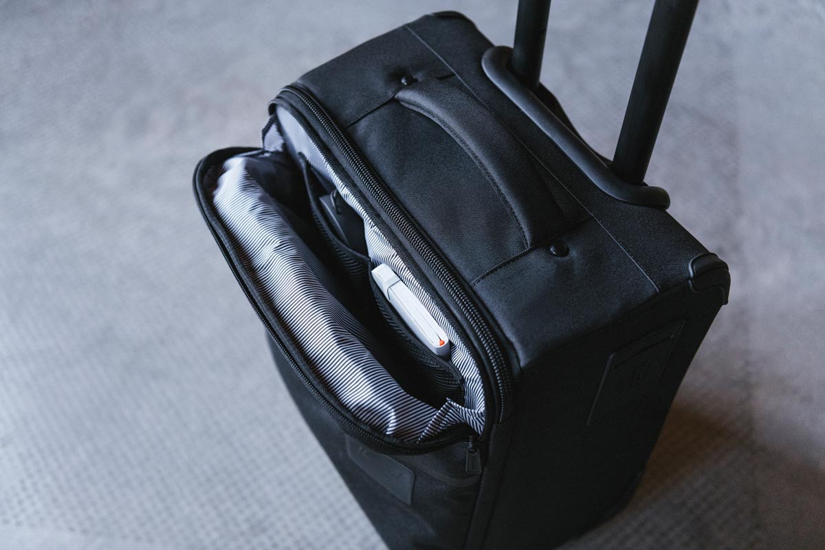 An unzipped front pocket of the Highland Luggage Carry-On folded over to show it's internal organizer pocket