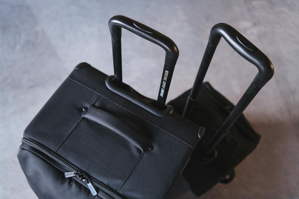 A couple of Highland Luggage Carry-Ons shot from above with their retractable luggage handles extended.